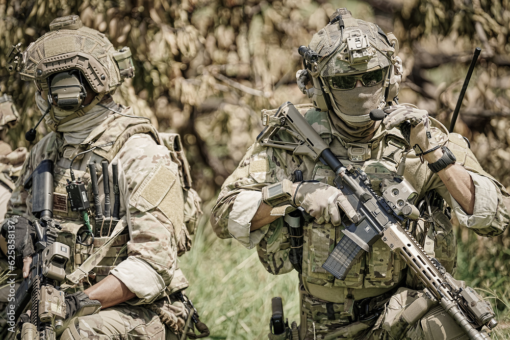 United States Army ranger during the military operation. Professional marine soldiers training with weapon on a military range. United States Army ranger during the military operation. Professional marine soldiers training with weapon on a military range.