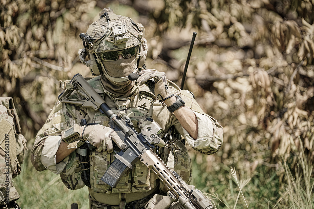 United States Army ranger during the military operation. Professional marine soldiers training with weapon on a military range. United States Army ranger during the military operation. Professional marine soldiers training with weapon on a military range.