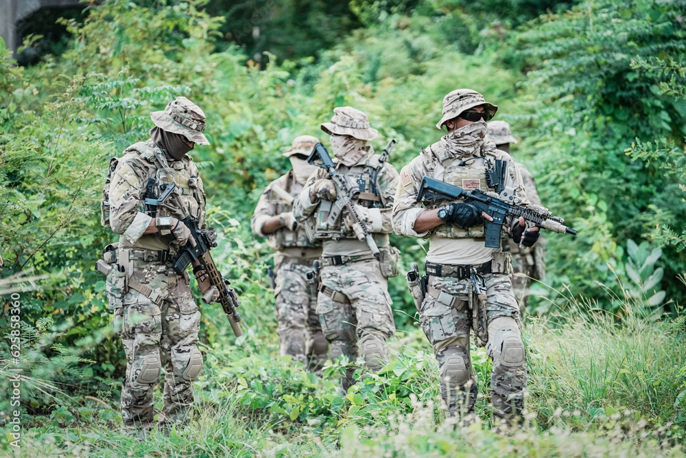 United States Army ranger during the military operation. Professional marine soldiers training with weapon on a military range. United States Army ranger during the military operation. Professional marine soldiers training with weapon on a military range.