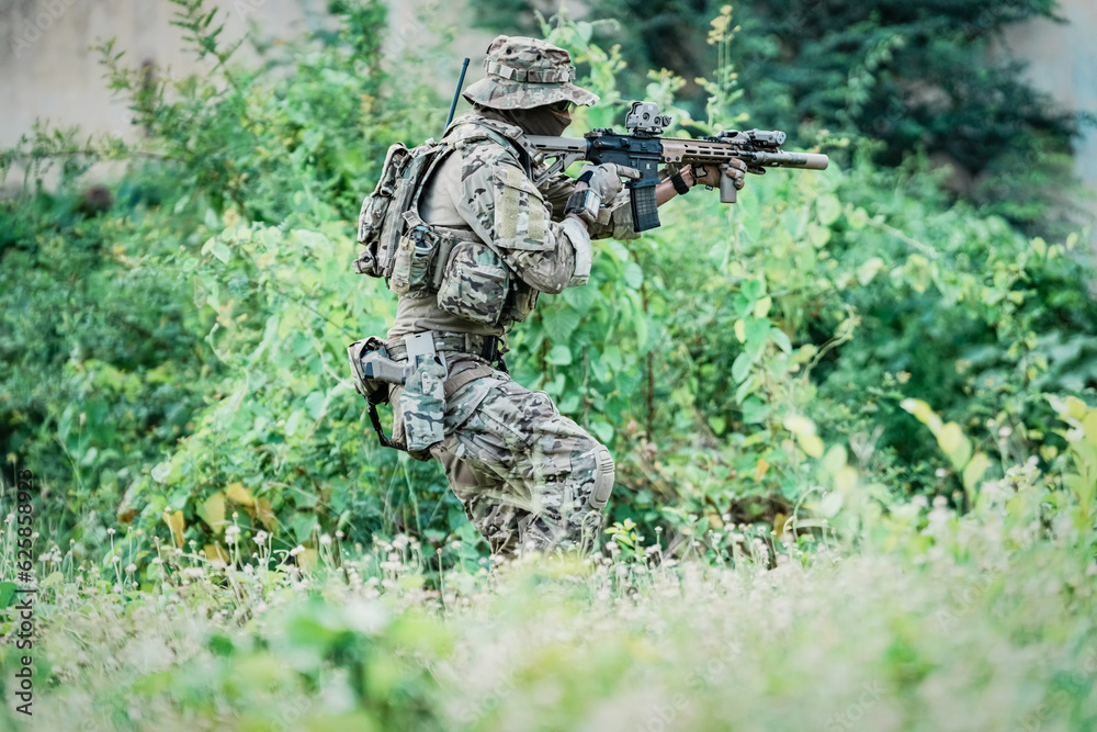 United States Army ranger during the military operation. Professional marine soldiers training with weapon on a military range. United States Army ranger during the military operation. Professional marine soldiers training with weapon on a military range.