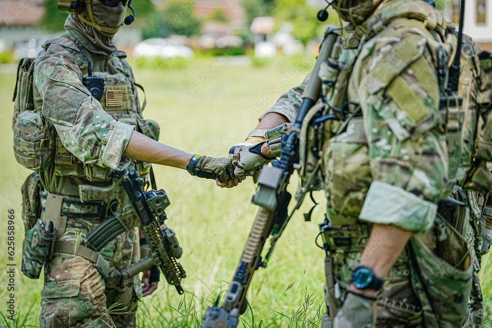 Fototapeta premium United States Army ranger during the military operation. Professional marine soldiers training with weapon on a military range.