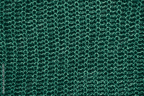 Handmade knitted material with macro weave threads.