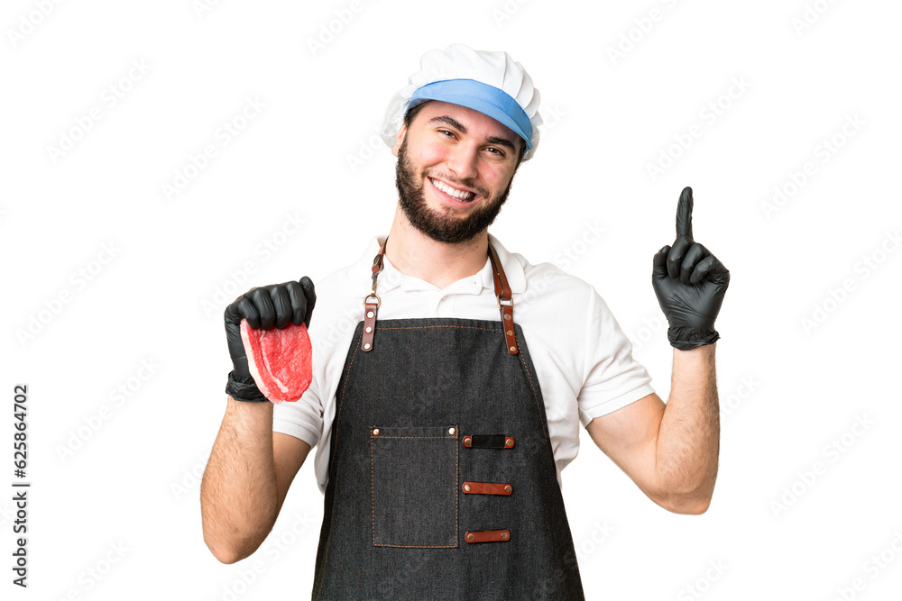 Butcher man wearing an apron and serving fresh cut meat over isolated chroma key background showing and lifting a finger in sign of the best Butcher man wearing an apron and serving fresh cut meat over isolated chroma key background showing and lifting a finger in sign of the best