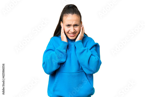 Young Arabian woman over isolated chroma key background frustrated and covering ears © luismolinero