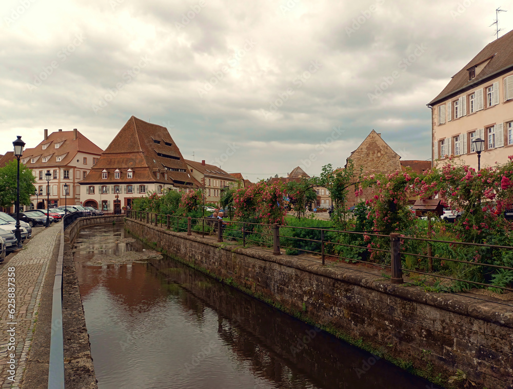 Historische Altstadt von Wissembourg (Weißenburg) am Fluss Lauter im Elsass mit dem Maison du sel (hinten) in Frankreich an der Grenze zu Rheinland-Pfalz.