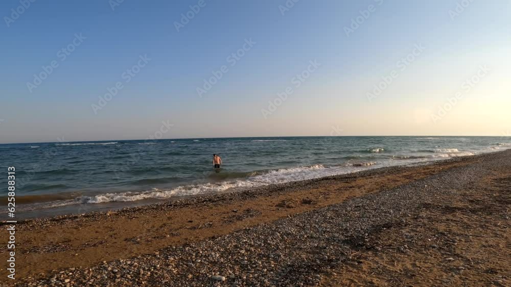 Lonely guy getting in the sea to swim at evening. Mediterranean beach, Side, Antalya, Turkey.
Lonely guy getting in the sea to swim at evening. Mediterranean beach, Side, Antalya, Turkey.