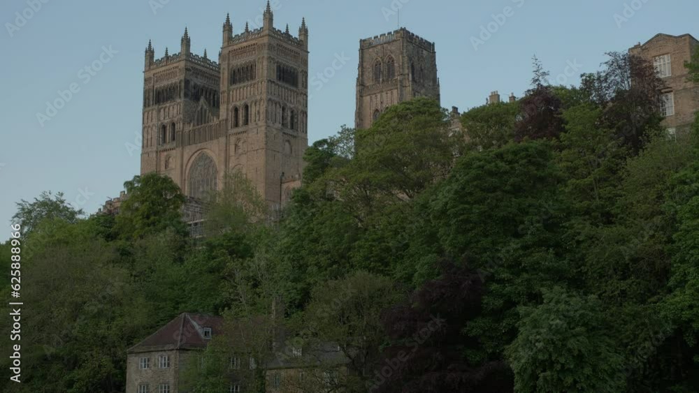 Camera tilts up from River Wear to Durham Cathedral at an iconic location. Shot on a sunny spring evening Camera tilts up from River Wear to Durham Cathedral at an iconic location. Shot on a sunny spring evening