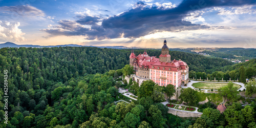 A beautiful aerial panorama of a castle in the woods in summer.