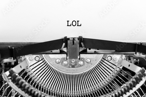 LOL word closeup being typing and centered on a sheet of paper on old vintage typewriter mechanical