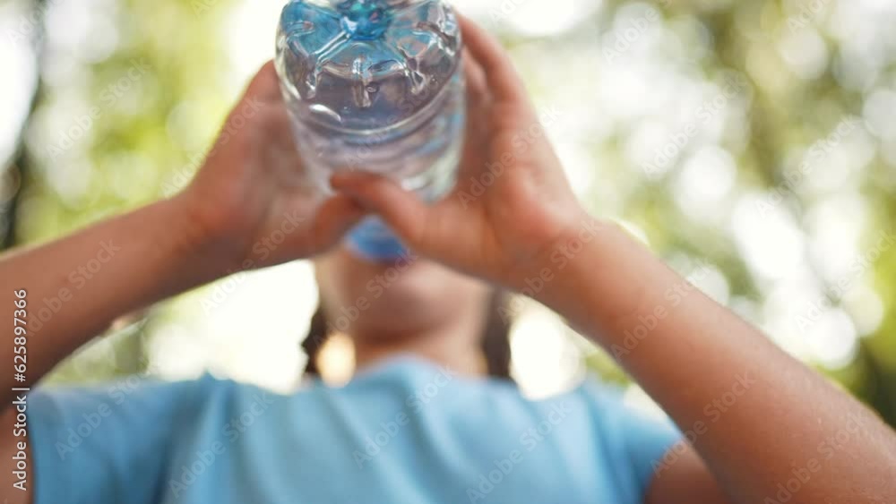 child drinking water from a plastic bottle lifestyle. water shortage