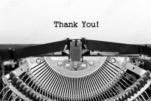 Thank You phrase closeup being typing and centered on a sheet of paper on old vintage typewriter mechanical