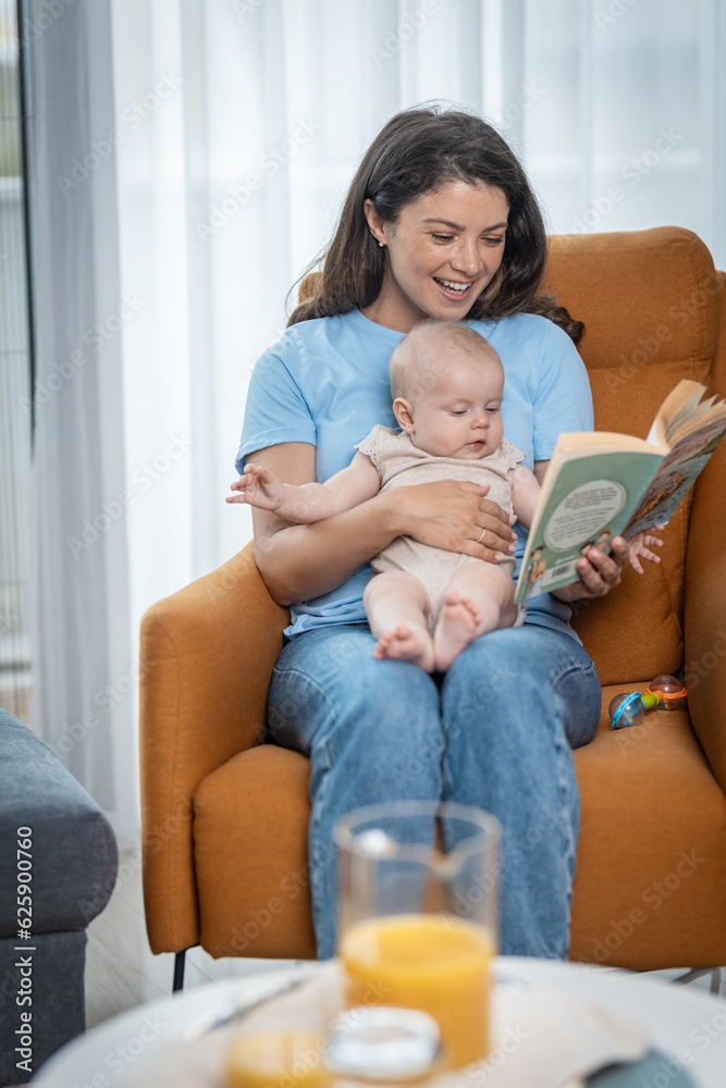 Mother and her baby enjoys reading fairy tale book Mother and her baby enjoys reading fairy tale book