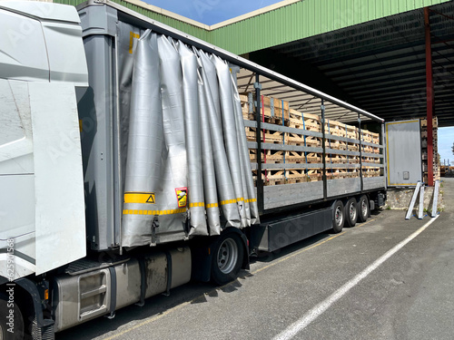 Transportation of car parts in wooden boxes in a semi-trailer truck