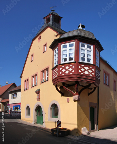 Renaissance town hall with half-timbered oriel window in the old village of Frei-Laubersheim in Germany photo