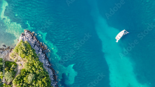 Drone view of a sailing yacht. Luxury transportation. Vacationing people. Vacation and holidays. Summer time for sea travel. The sea bay. Photo for background and wallpaper. Mediterranean Sea. 