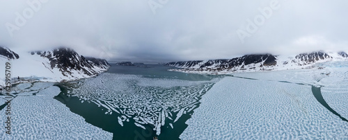 Extreme wide angle panoramic view  of some islands in Svalbard archipelago and the frozen water of the Arctic Ocean.