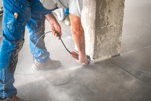 Canvas Print Crop worker cutting concrete with angle grinder