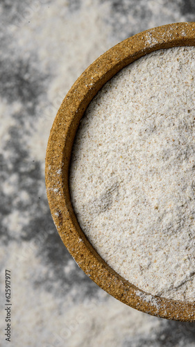 Farmer's flour in a plate on a blurry background