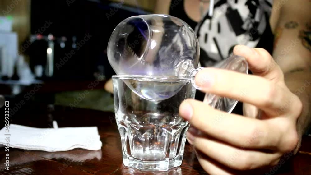 Bartender sets fire to sambuca on glasses
Bartender sets fire to sambuca on glasses