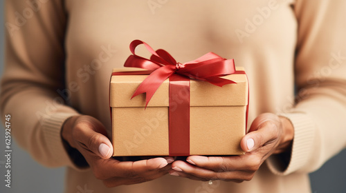 Female hands holding a gift box. Concept of birthday, christmas, valentine´s day. Generative AI.  © Aul Zitzke