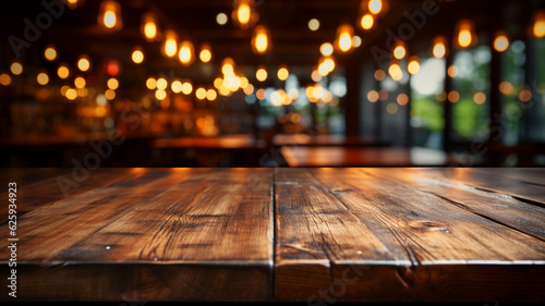Fotografia The empty wooden table top with blur background of restaurant at night
