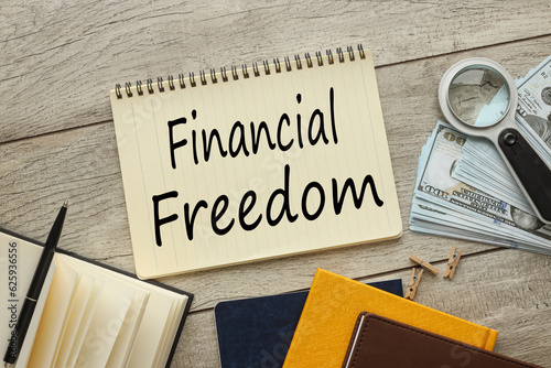Financial Freedom yellow notepad and text on notebook page photo