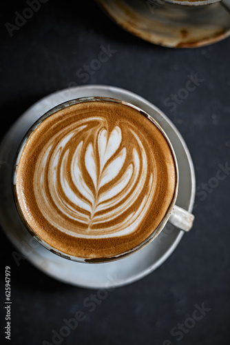hot latte art coffee on dark background