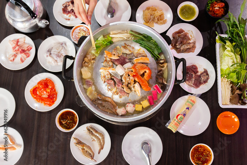 Chonburi Thailand - April 8 2023 : Thai food style. shabu sukiyaki or Moo-Ka-Ta griiled pork.