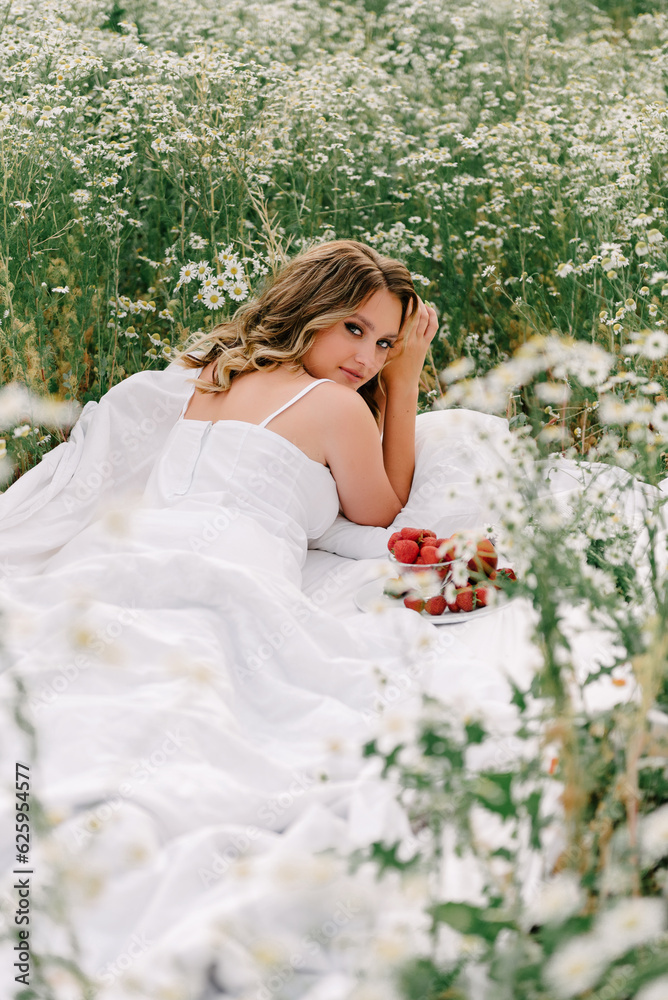 Beautiful girl lies in a chamomile field Beautiful girl lies in a chamomile field