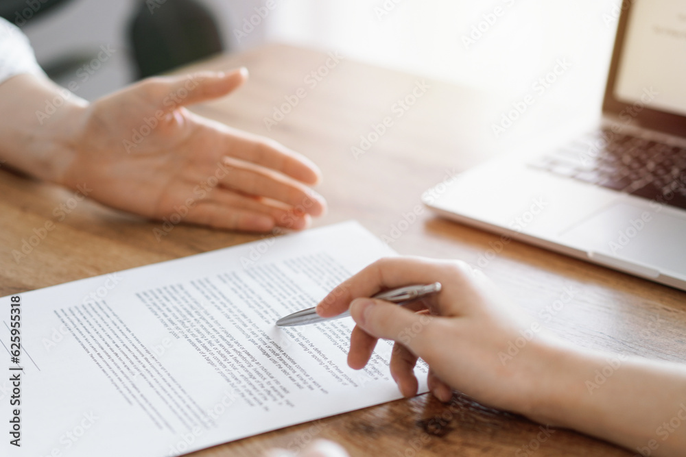 Business people discussing contract signing deal while sitting at the wooden table in office. Partners or lawyers working together at meeting. Teamwork, partnership, success concept