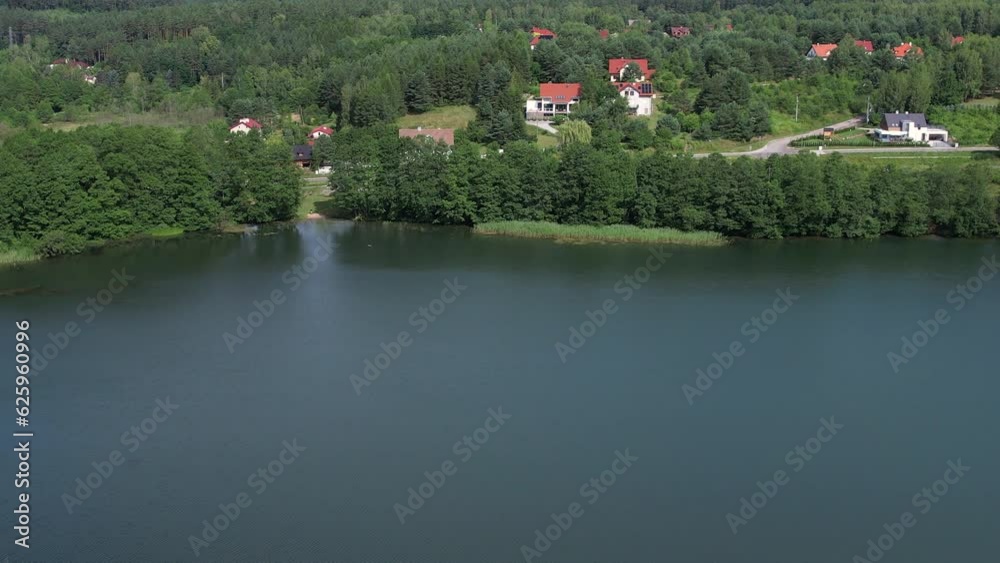 Majestic Aerial View of Calm Lake With Islands in Poland. Village Houses on Shore of Paradise Lake. Peaceful Reflected on Water. Spectacular Beautiful Lake Aerial View. Epic Amazing Nature Landscape. Majestic Aerial View of Calm Lake With Islands in Poland. Village Houses on Shore of Paradise Lake. Peaceful Reflected on Water. Spectacular Beautiful Lake Aerial View. Epic Amazing Nature Landscape.