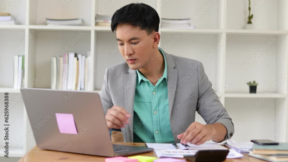 Excited and happy businessman working in office after successful goal work.