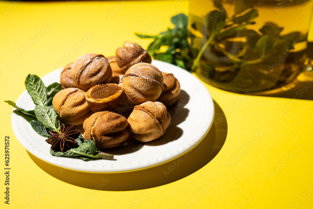 Homemade nut cookies with condensed milk on a yellow background Homemade nut cookies with condensed milk on a yellow background