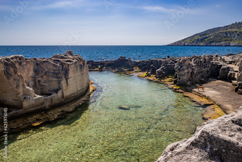 The amazing natural pools of Marina Serra, in Puglia, Salento, Tricase. The clear and crystalline turquoise sea, between the rocky cliff. The blue sky, in the summer. photo