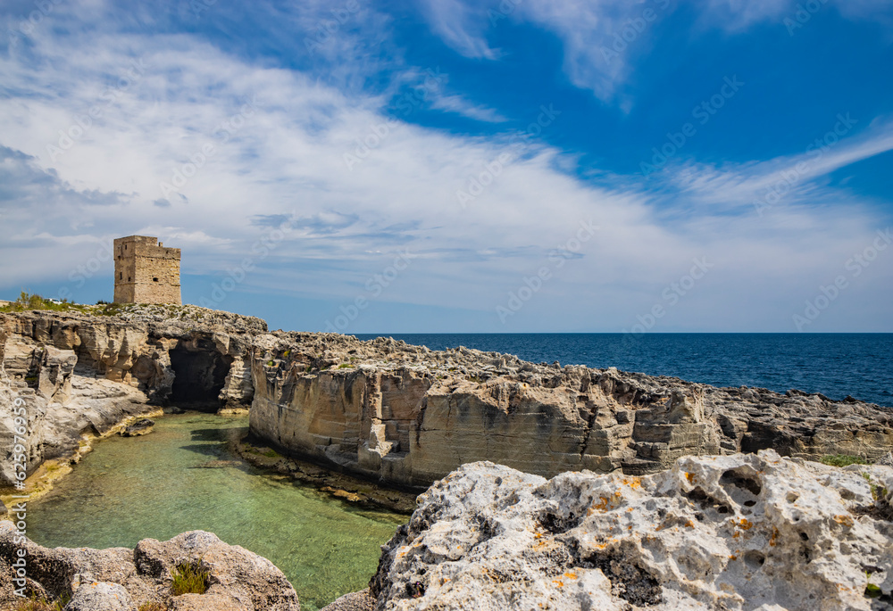 The amazing natural pools of Marina Serra, in Puglia, Salento, Tricase. The clear and crystalline turquoise sea, between the rocky cliff. The blue sky, in the summer. The ancient watchtower.