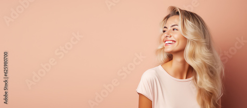 Smiling young woman with blonde long groomed hair isolated on pastel flat background with copy space. Blonde hair care products banner template, hair salon. photo
