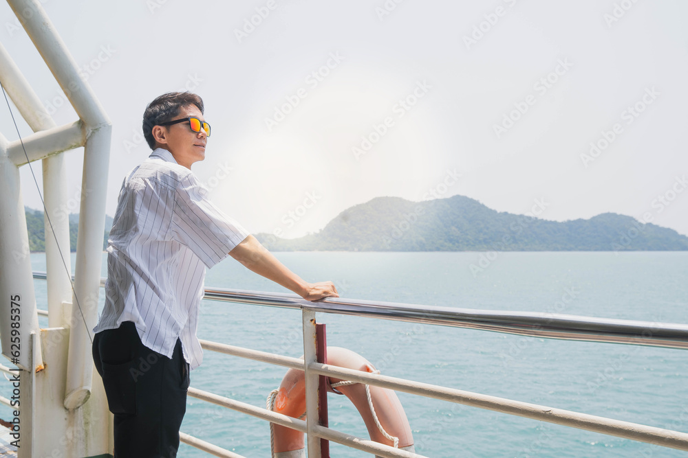 Handsome man with smartphone open arms celebrate his holiday freedom while travel on cruise ship. Handsome man with smartphone open arms celebrate his holiday freedom while travel on cruise ship.