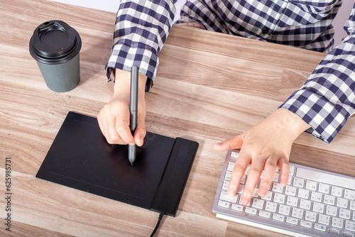 Artist drawing something on graphic tablet