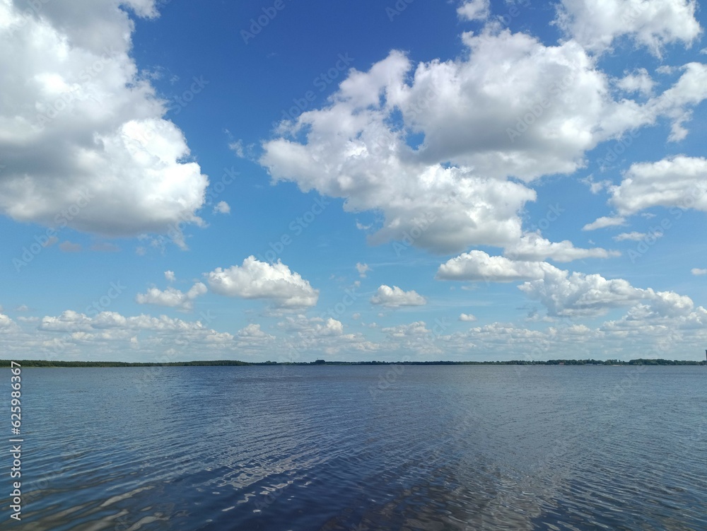 Rekyva lake during sunny day. Cloudy day. Wavy lake.. White and gray colored clouds. Horizon over water.. Rekyvos ezeras.