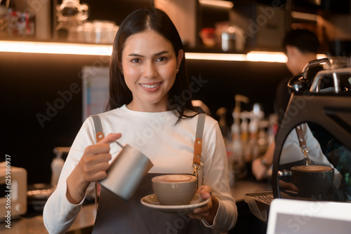 A young woman barista working in modern coffee shop