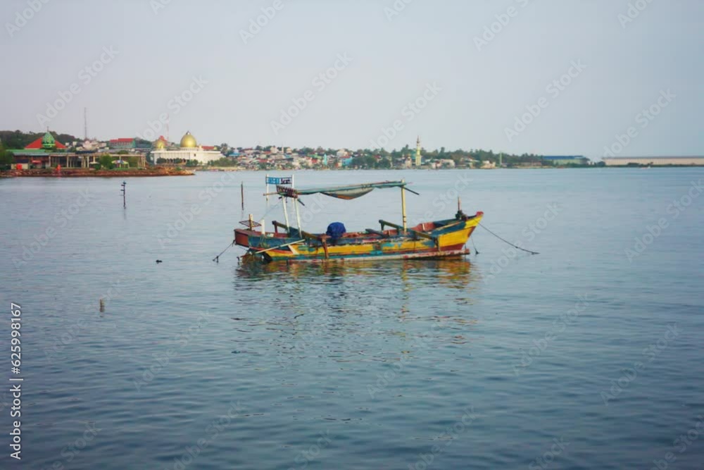a wooden boat belonging to a fisherman anchored on the beach on a hot day a wooden boat belonging to a fisherman anchored on the beach on a hot day