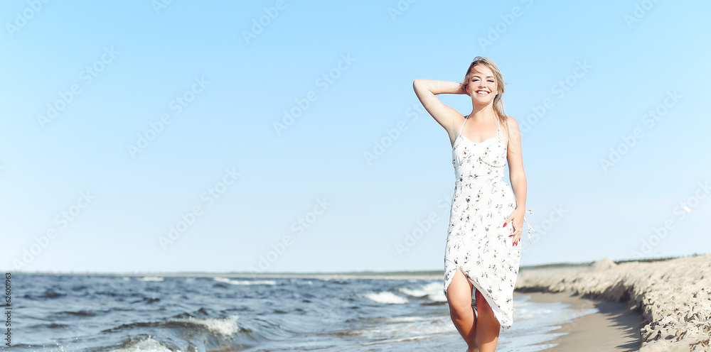 Happy blonde beautiful woman having fun on ocean beach while dancing in waves Happy blonde beautiful woman having fun on ocean beach while dancing in waves