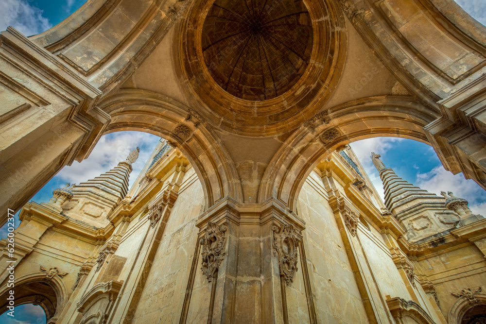 Detail of the second body of the tower of the cathedral of Santa Maria de Murcia, Spain, in baroque style with niches and saints in the domes