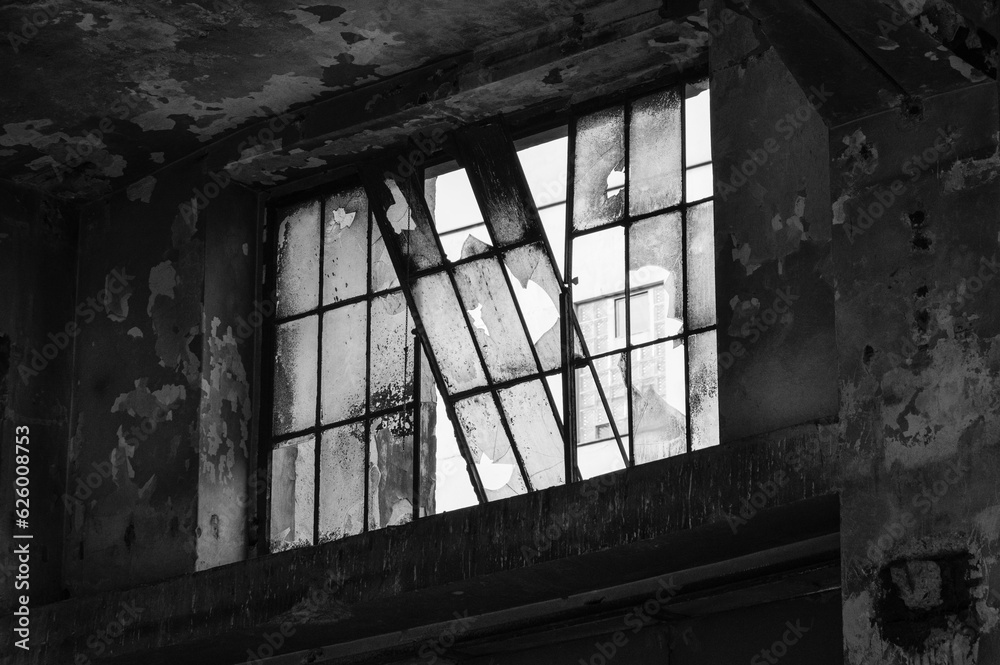 Fototapeta premium Shattered and broken glass windows of an abandoned industrial building. Stara hala - old industrial building in Vysocany, Prague