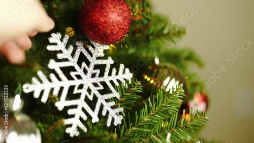 Green Christmas tree decorated with colorful balls and a big star