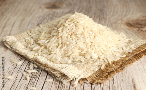 White rice on wooden background