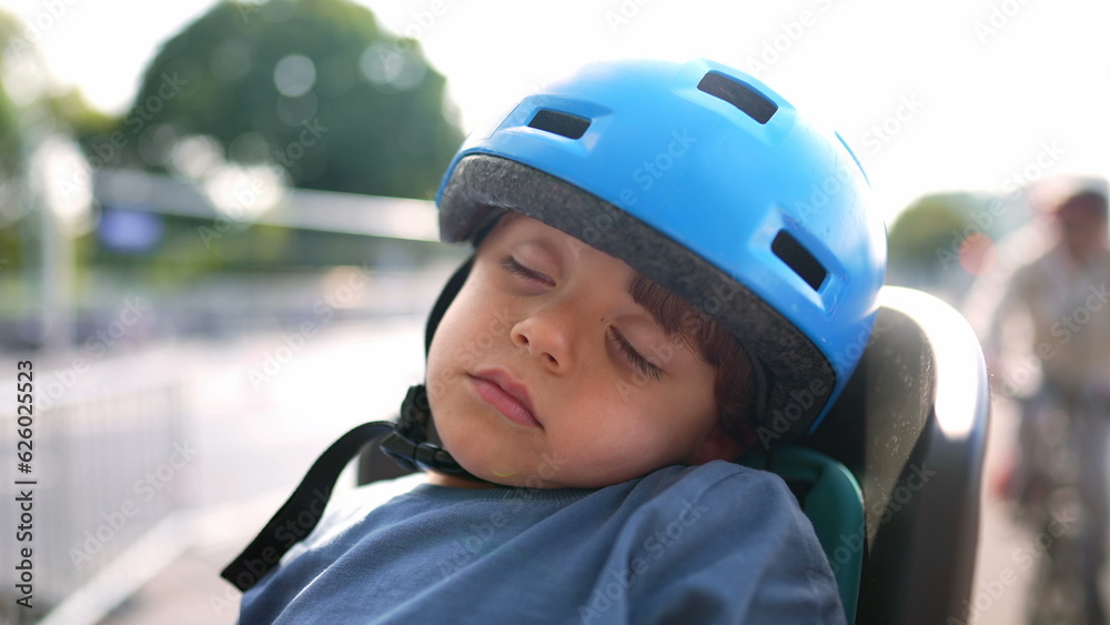 Little boy sleeping wearing helmet child asleep with bicycle helmet