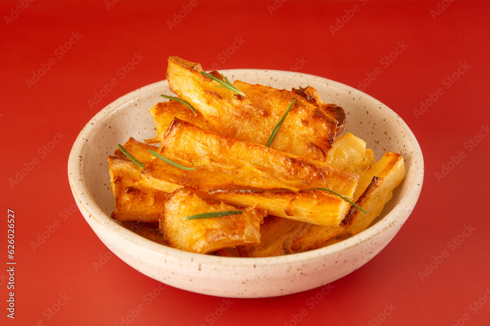 Delicious front view Fried Cassava in Handcrafted White Ceramic Bowl on Red Studio Background Delicious front view Fried Cassava in Handcrafted White Ceramic Bowl on Red Studio Background