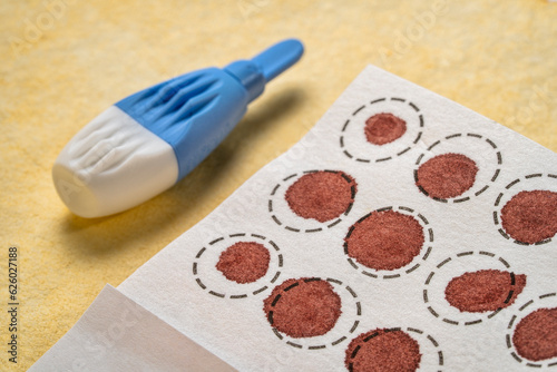 lancet and dry blood spots on a fiber filter for laboratory analysis, home health testing concept