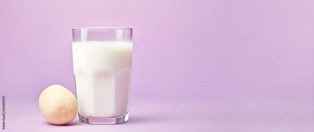 Vegan potato milk from purple potato in glass on purple background. Generative AI content Vegan potato milk from purple potato in glass on purple background. Generative AI content